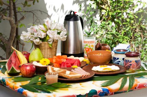 a table with a plate of food on a table at Casa de Don Pablo Hostel in Oaxaca City