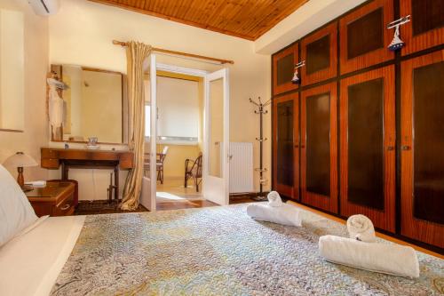 a bedroom with a large bed with towels on it at ELENI'S TRADITIONAL HOUSE IN AGRAFI in Agrafoí