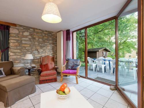 a living room with a couch and a table at Spacious holiday home in Vielsalm with garden in Vielsalm