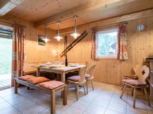 a dining room with a table and chairs at Wooden chalet in Stadl an der Mur with sauna in Stadl an der Mur