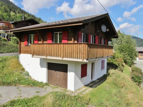 a house with a balcony on top of a hill at Attractive chalet in Fiesch Wiler with views in Fiesch