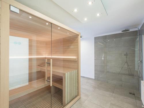 a bathroom with a shower and a glass wall at Erzberg Royal in Eisenerz