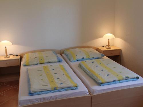 two twin beds in a room with two lamps at Country holiday home in Damshagen with sauna in Damshagen
