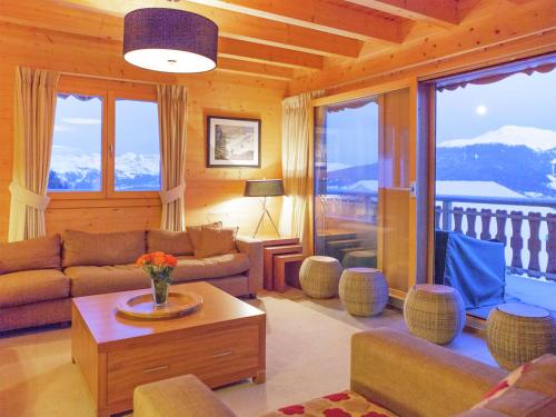 a living room with a couch and a table at Chalet in Les Collons near Ski Slope in Les Collons