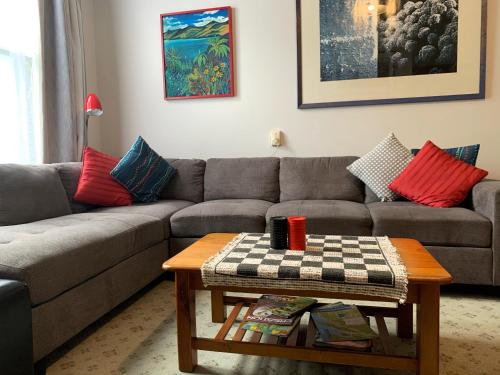 a living room with a couch and a table at The Villa in Picton