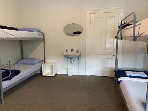 a room with two bunk beds and a sink at The Villa in Picton