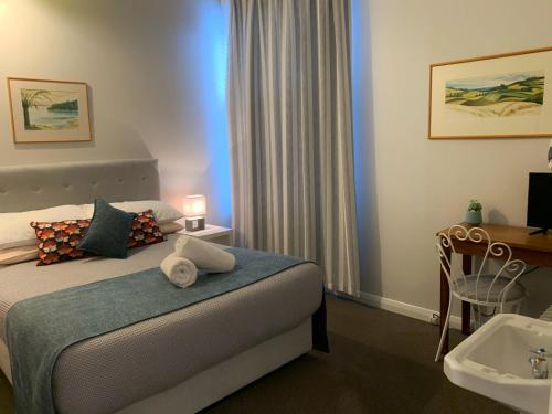 a hotel room with a bed and a sink at The Villa in Picton