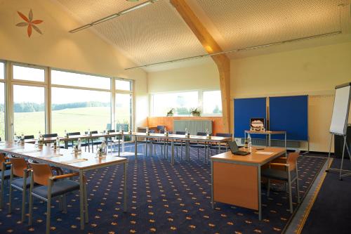 a classroom with tables and chairs in a room at Gastagwirt in Eugendorf