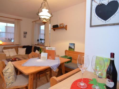 a living room with a table and two wine glasses at Holiday home in Halblech near a ski resort in Halblech