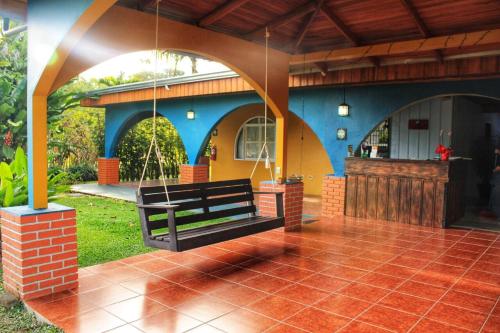 a porch with a bench on a house at Casona Rústica & Bungalow in Fortuna