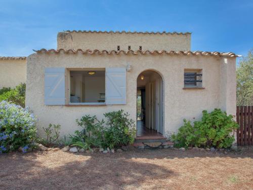 a house with a large window on the side of it at Bright Home in Carg se Corse du Sud with Barbecue in Cargèse