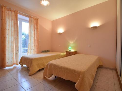 zwei Betten in einem Zimmer mit Fenster in der Unterkunft Holiday home with pool, enclosed garden in Saint-Pompont