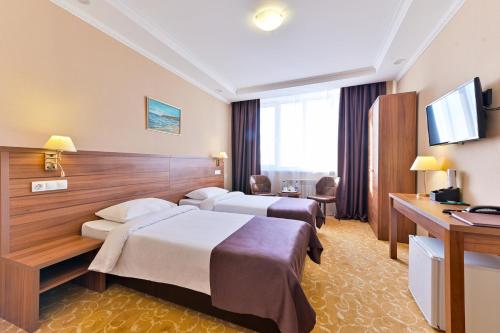 Greenwich Hotel tesisinde bir odada yatak veya yataklar