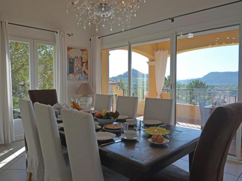 a dining room with a table and chairs at Spacious villa in Vidauban with seasonal private pool in Vidauban