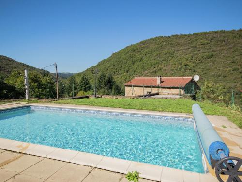 a swimming pool with a house in the background at Graceful Holiday Home in Montclar with bubble bath in Montclar