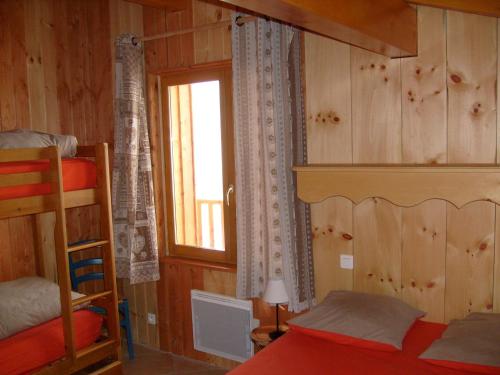 a bedroom with a bunk bed and a window at Chalet in Le Thillot with Skiing & Horse Riding Nearby in Le Ménil