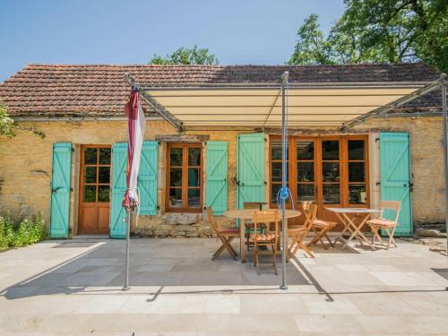 a house with a table and chairs in front of it at Mansion in Lavercanti re with Private Pool in Lavercantière