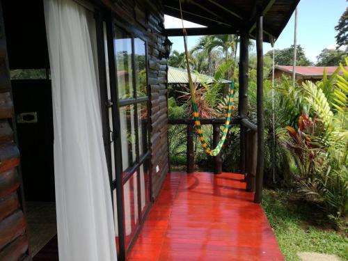 an open door to a house with a porch at Casona Rústica & Bungalow in Fortuna