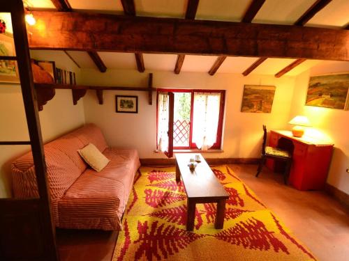 a living room with a couch and a table at Peaceful Retreat with Pool in San Marcello Pistoiese