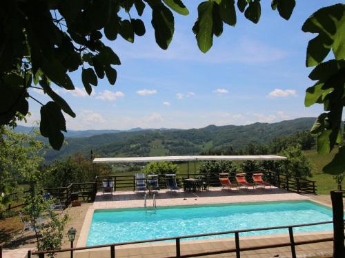 a swimming pool with a view of the mountains at Farmhouse in Apecchio with Pool & Spa in Apecchio