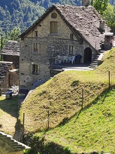 a large stone building on top of a hill at Tepilanti in Cerentino