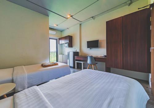 Una cama o camas en una habitación de Bhava Residence