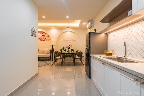a kitchen with a table and a dining room at Maison de Rose in Quy Nhon