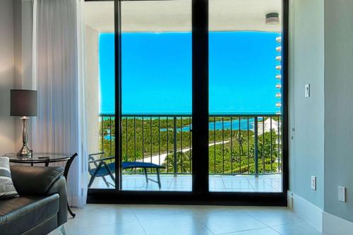 a living room with a view of a balcony at Sst3 #701 in Marco Island