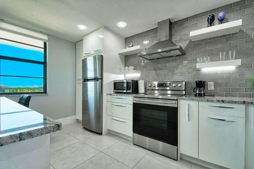 a kitchen with stainless steel appliances and a large window at Sst3 #701 in Marco Island