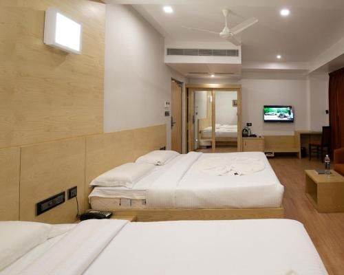 מיטה או מיטות בחדר ב-PPH Living Railotel Coimbatore