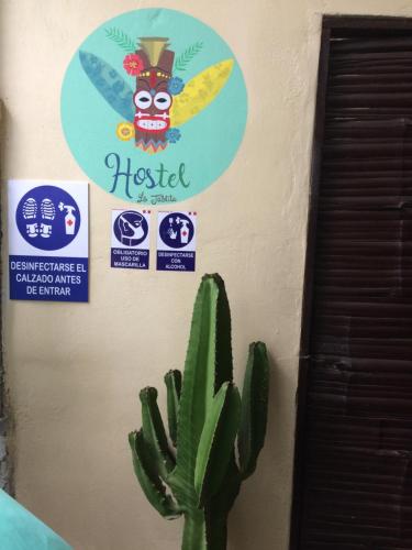 a sign on a wall next to a cactus at La Tablita in Zorritos