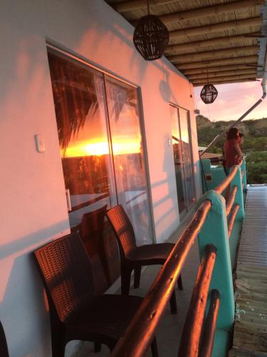 a deck of a boat with chairs and a sunset at La Tablita in Zorritos