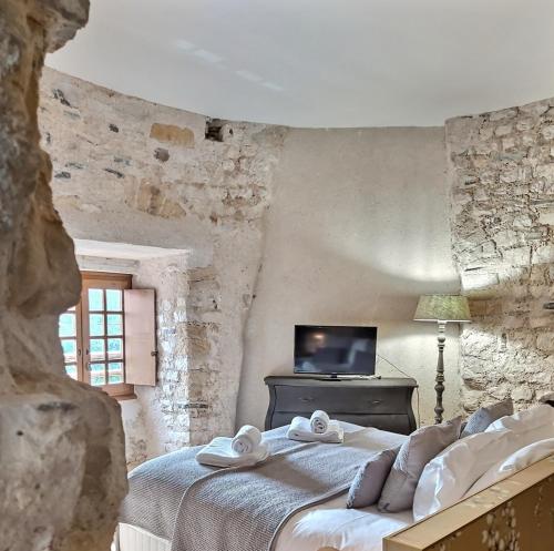 a bedroom with a bed with towels on it at Hôtel des Basses Pyrénées - Bayonne in Bayonne