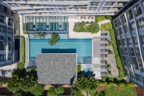 an overhead view of a pool between two buildings at Arden Hotel and Residence by At Mind in Pattaya Central