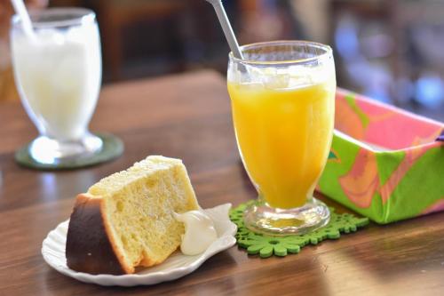 a table with a plate of bread and a glass of orange juice at Ichie in Tanabe