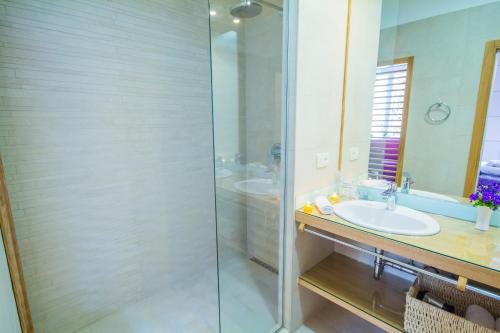 a bathroom with a glass shower and a sink at Peninsula Luxury Rooms in Zadar