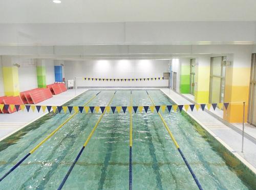 a large swimming pool with water in it at Hida Takayama Onsen Hida Hotel Plaza in Takayama