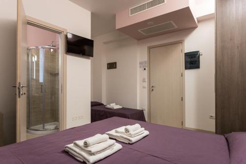 Łóżko lub łóżka w pokoju w obiekcie Hotel Gioia