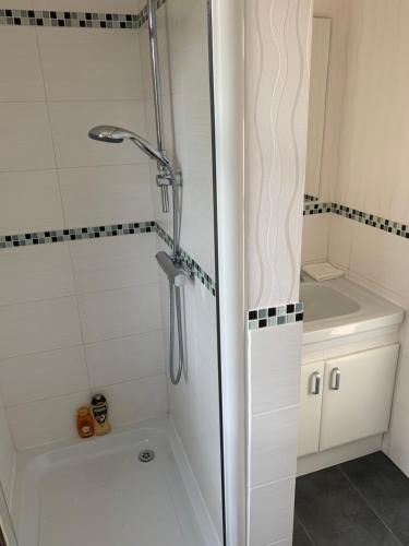a shower with a glass door in a bathroom at Le Pontet in Miramont-de-Guyenne