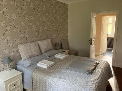 a bedroom with a bed with two towels on it at Le Pontet in Miramont-de-Guyenne