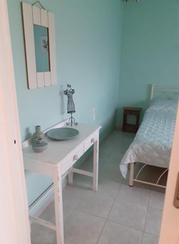 a white bathroom with a sink and a bed at Sea and Sun in Amoudara Herakliou