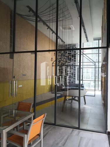 a room with glass walls and a table and chairs at Spacious Big Room, Designed & Quiet Family Home, Eclipse in Cyberjaya by Flexihome-MY in Cyberjaya