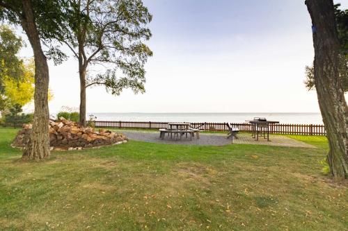 a park with picnic tables and the ocean in the background at Sleepy Eye Apartment, By Cohost in Preila