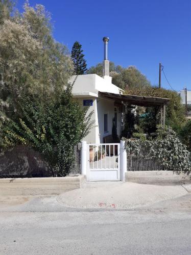a white house with a gate and a fence at Sea and Sun in Amoudara Herakliou