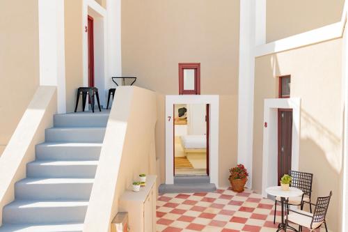 a staircase in a home with blue stairs at Nano Suites in Éxo Goniá