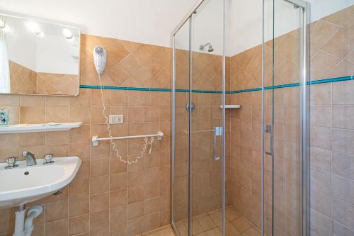 a bathroom with a shower and a sink at Appartamenti Vista Mare - Goelba in Capoliveri