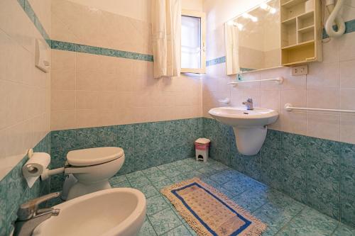 a bathroom with a toilet and a sink at Appartamenti Vista Mare - Goelba in Capoliveri