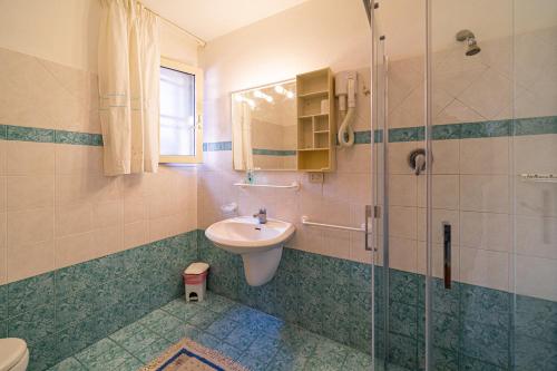 a bathroom with a sink and a shower at Appartamenti Vista Mare - Goelba in Capoliveri