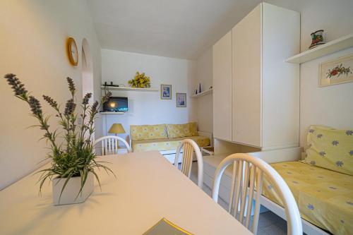 a living room with a table and chairs and a couch at Appartamenti Vista Mare - Goelba in Capoliveri