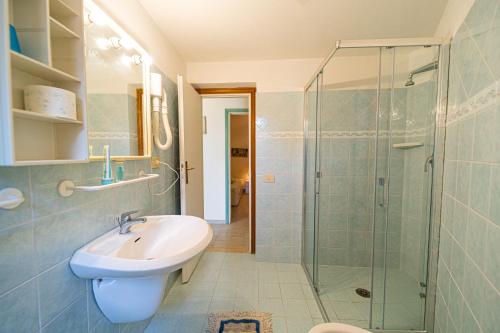 a bathroom with a sink and a glass shower at Appartamenti Vista Mare - Goelba in Capoliveri